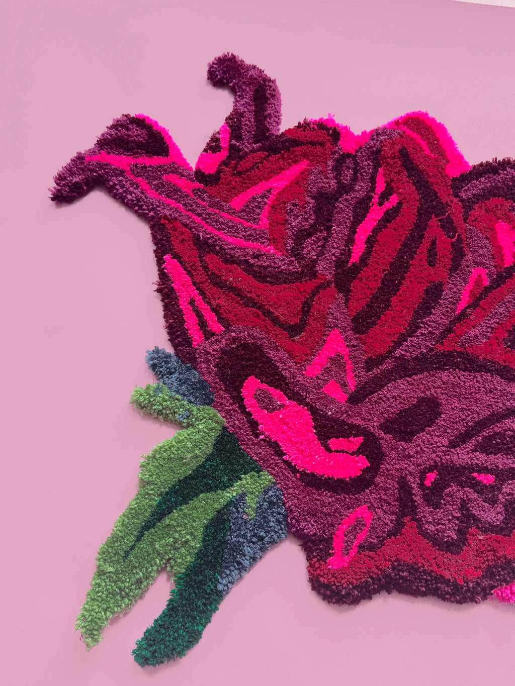Decorative rug with a floral design on a pink background