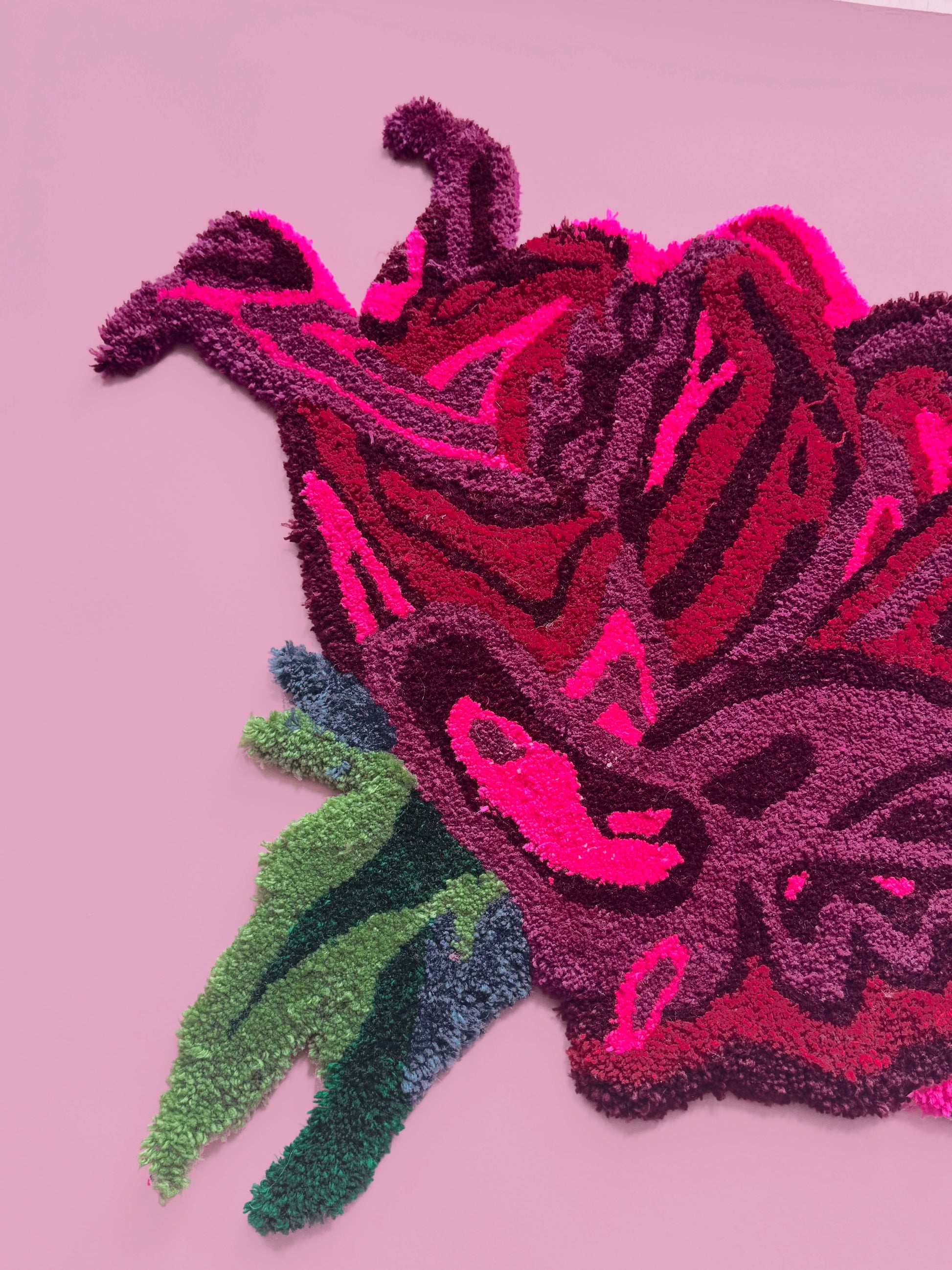 Decorative rug with a floral design on a pink background