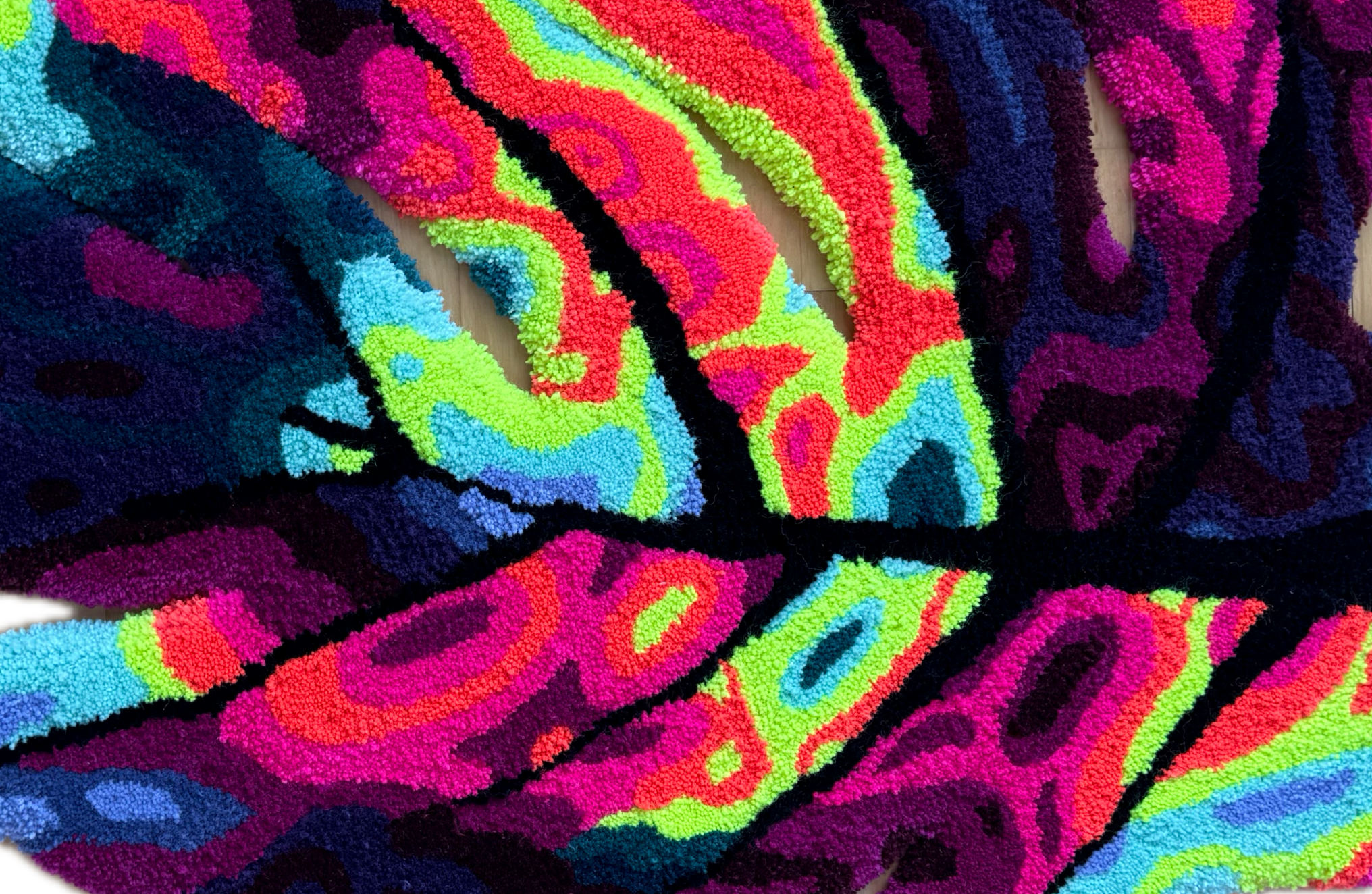 Floor rug/ carpet with colorful abstract pattern on a wooden floor