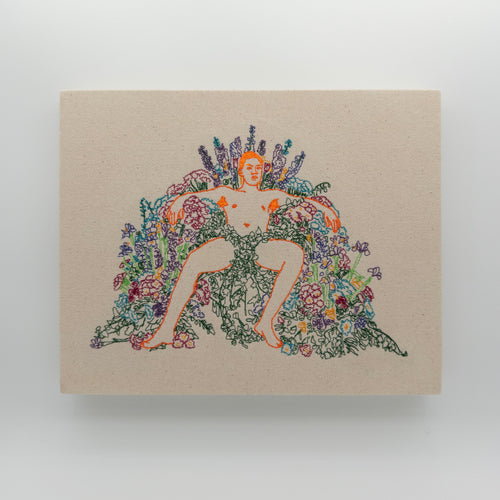 Ari: embroidered figure outlined in orange, arms spread across an arch of flowers, on natural canvas