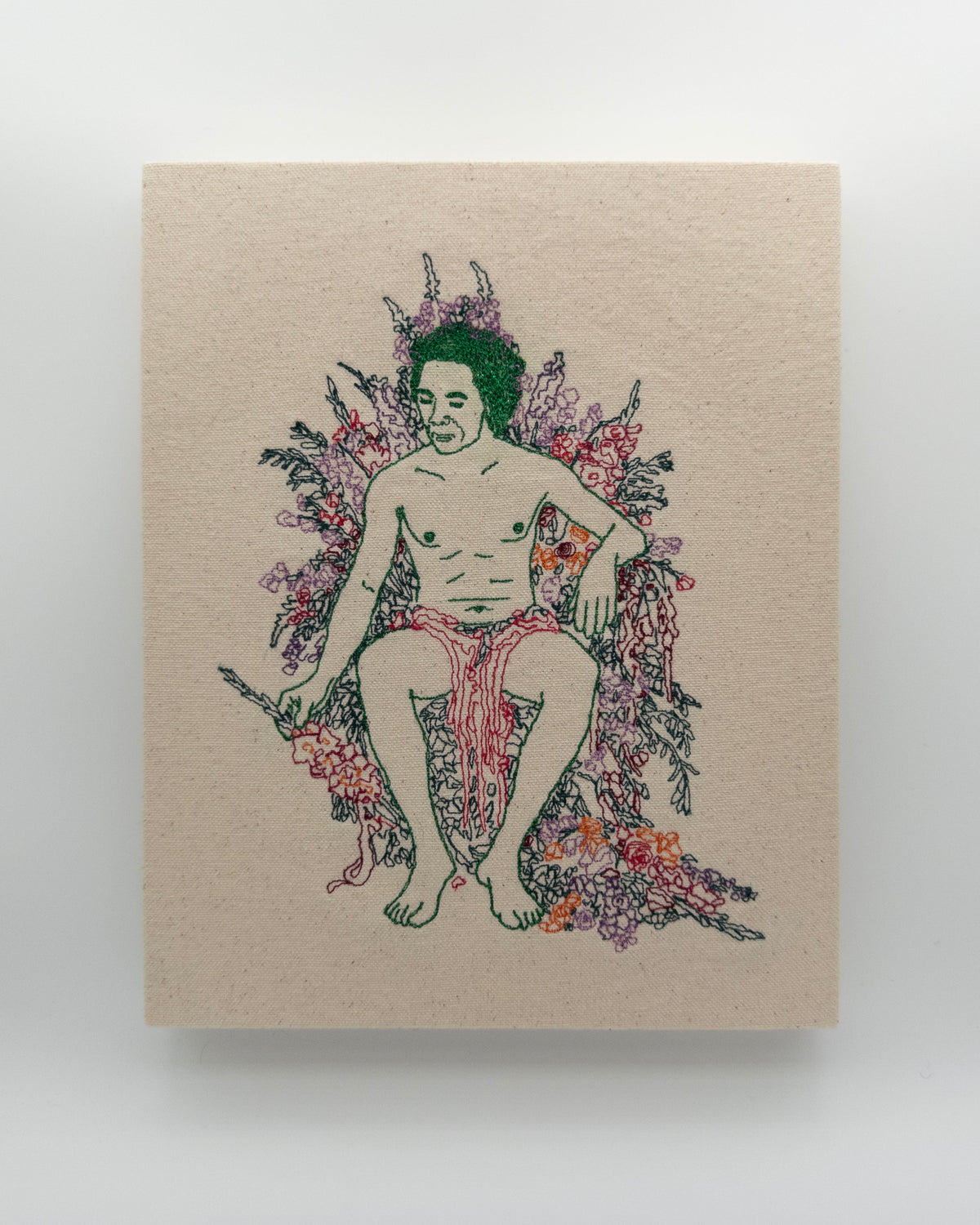 Sage: embroidered figure with green hair and a pink drape, seated among flowers, on natural canvas