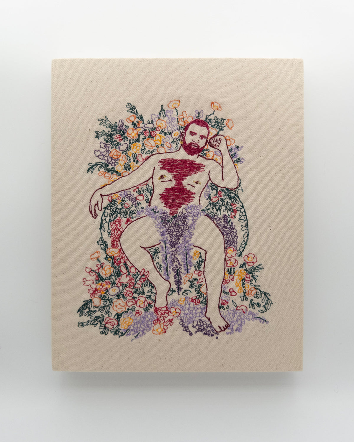 Shiraz: embroidered figure with a wine red beard, reclining among lavender and poppies, on natural canvas